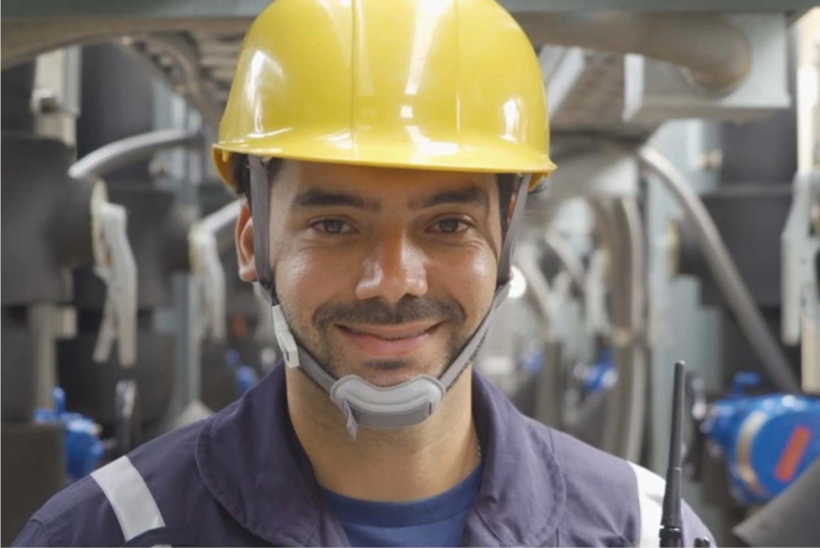 Man smiling with yellow hard hat on